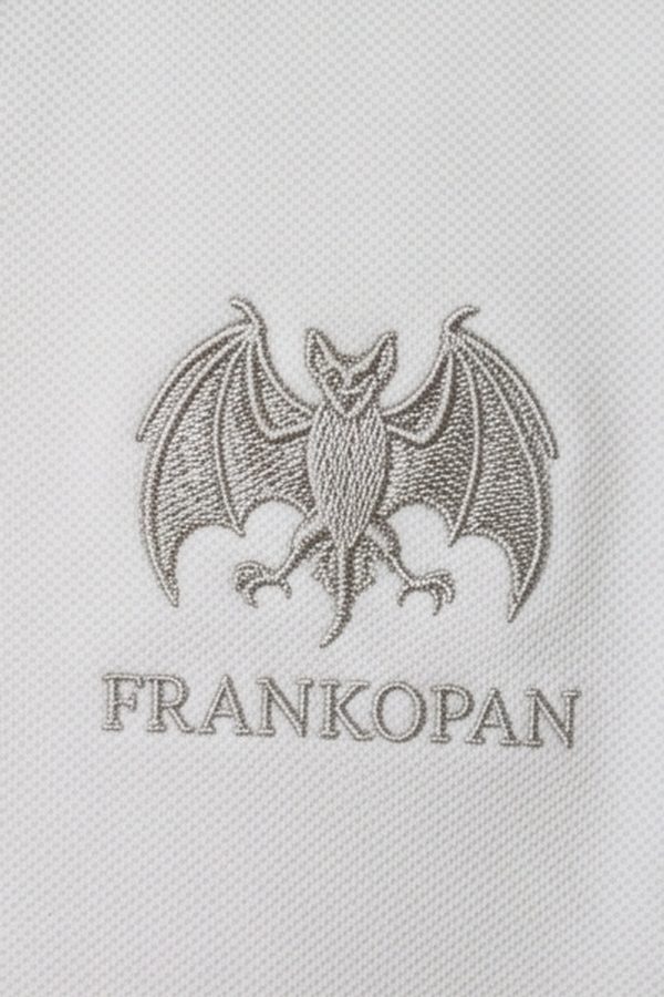 Close view of a grey embroidered emblem, a winged creature with spread wings, above the word Frankopan.