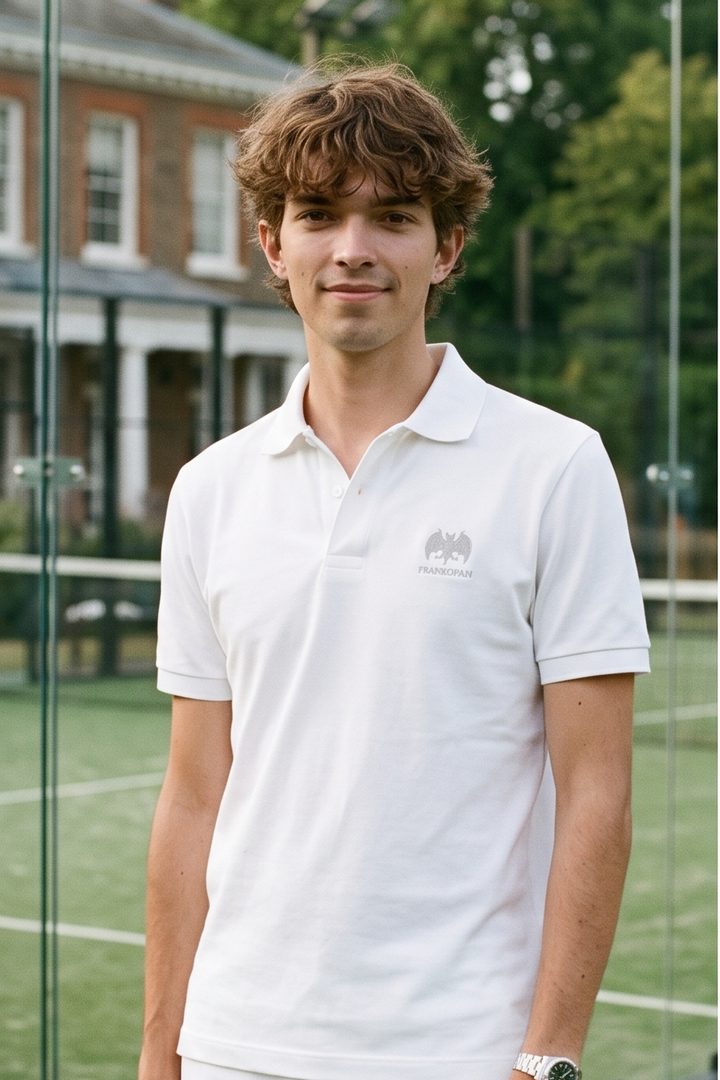 Front view. A player wears the white polo, collar open, with a small grey emblem above the word Frankopan on the left chest.